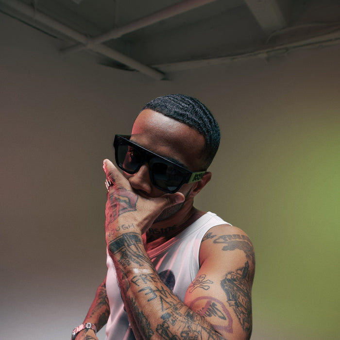 Vic Mensa posing on white cyc with black fabric. Shot by Colt Grice in Blackout Studio B at Apex Photo Studios