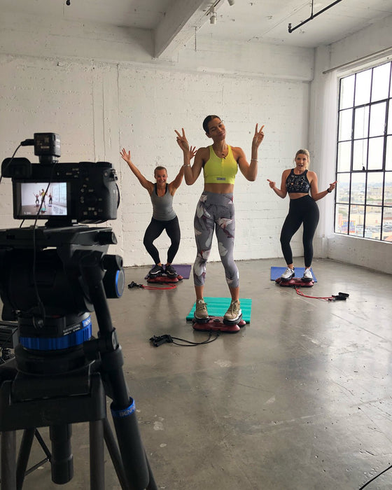 Group fitness class recording in progress with enthusiastic participants at Sunrise Studio, Apex Photo Studios' Studio D