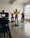 Group fitness class recording in progress with enthusiastic participants at Sunrise Studio, Apex Photo Studios' Studio D