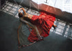 Fashion model in traditional attire lying on the floor at Sunrise Studio, part of Apex Photo Studios in Studio D with dramatic lighting and elegant poses