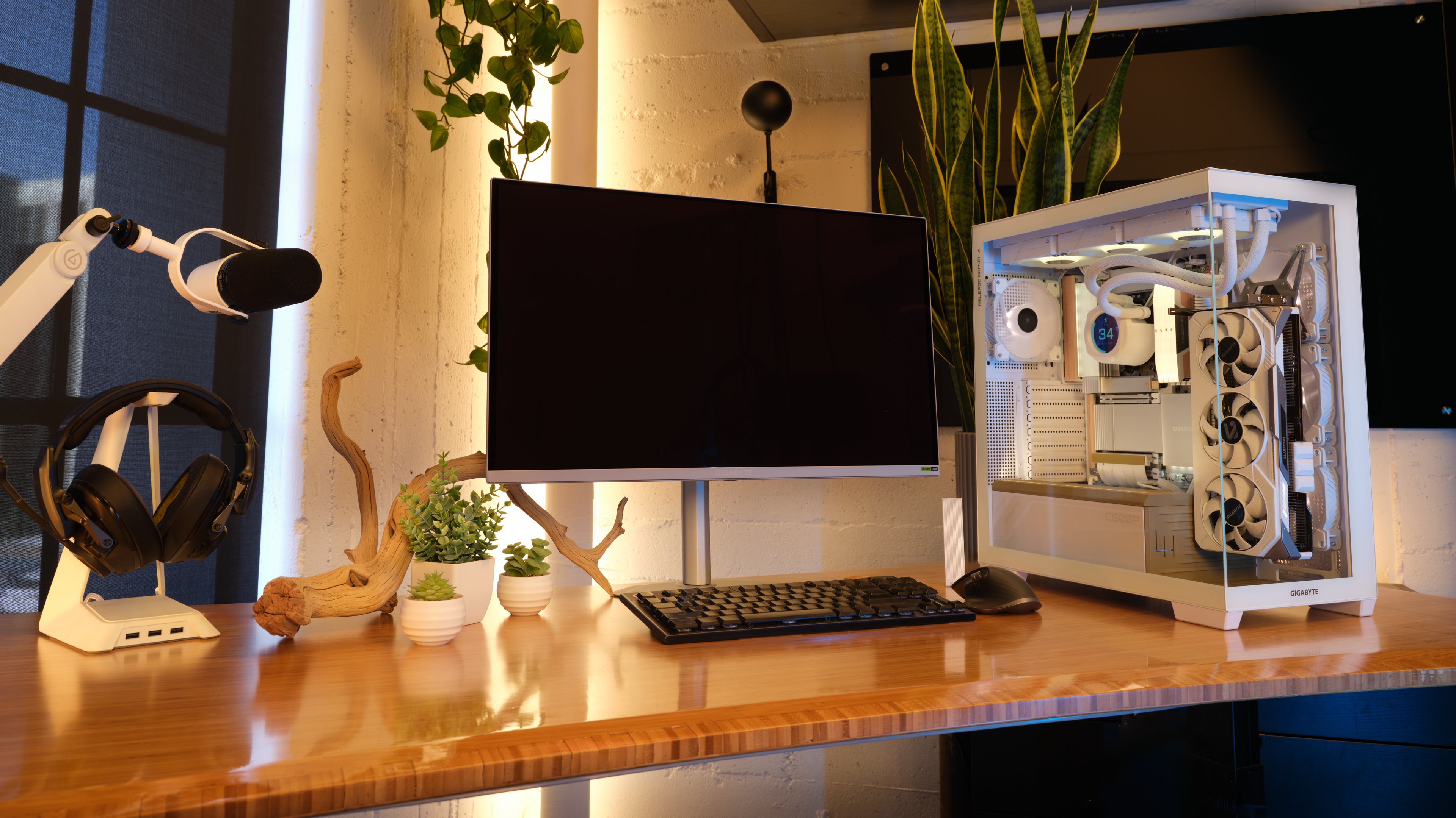 apex photo studios clean modern office set with warm wood desk, keyboard, mouse, monitor and open glass computer with all components in it.