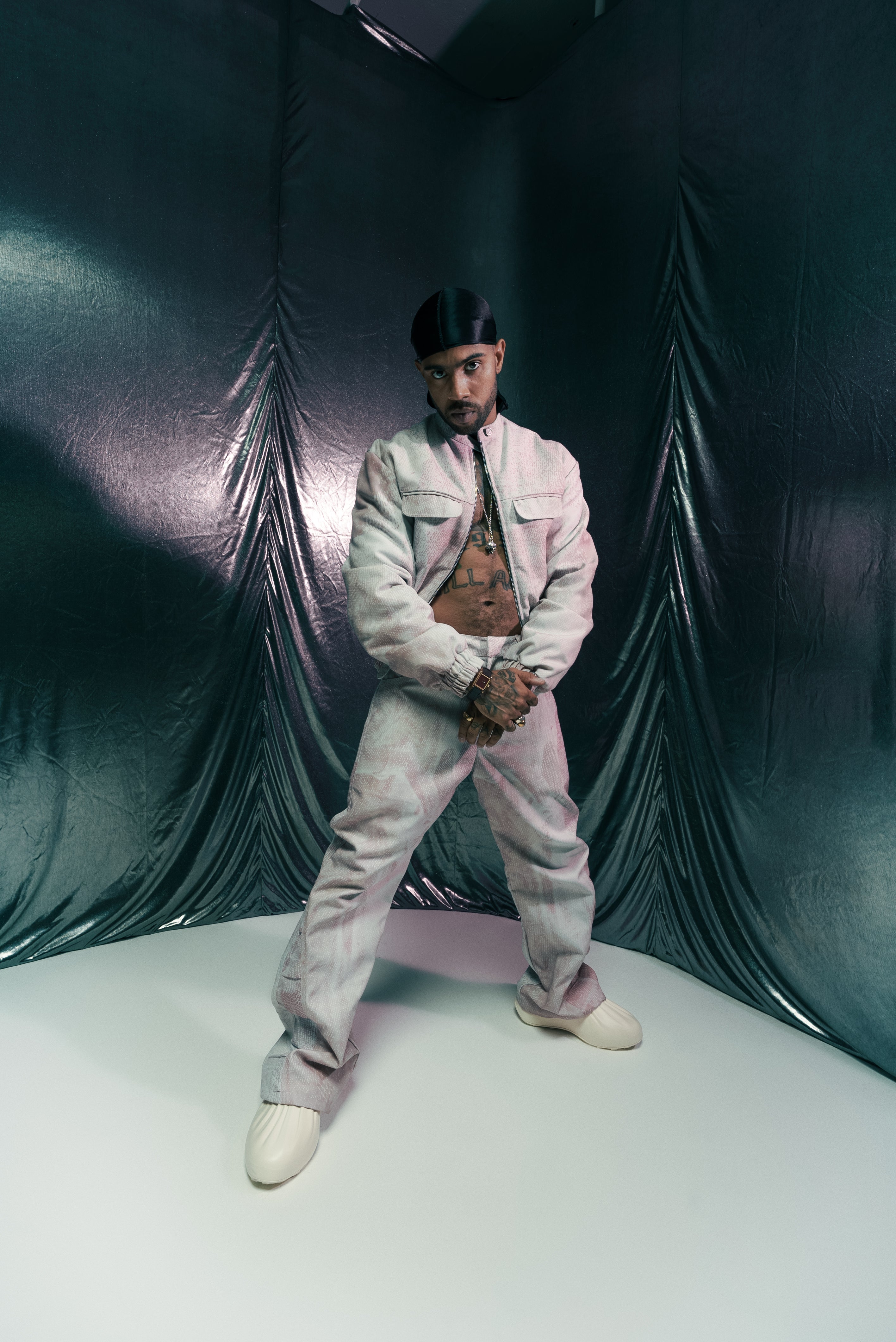 Vic Mensa posing on white cyc with black fabric. Shot by Colt Grice in Blackout Studio B at Apex Photo Studios