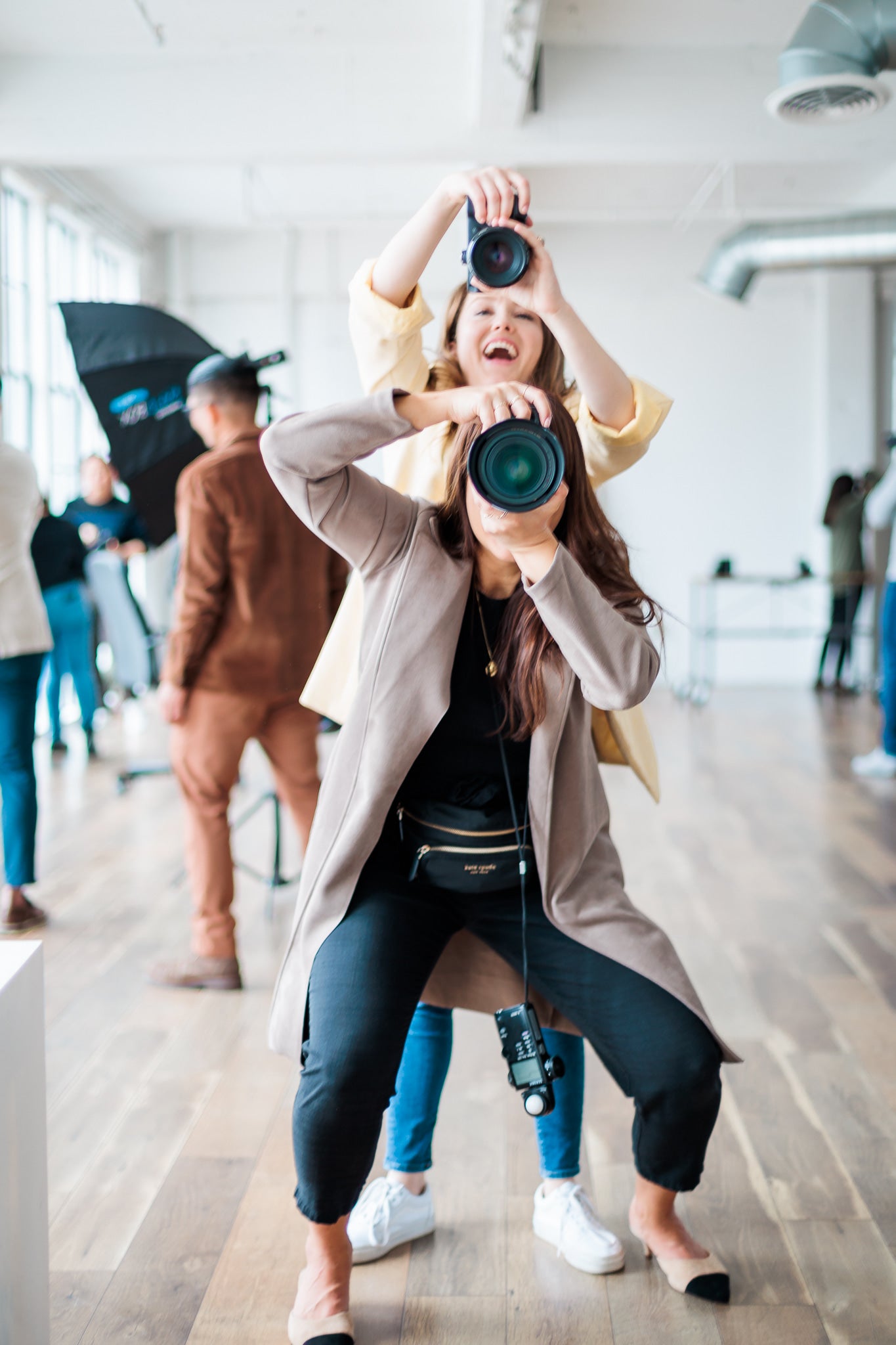 Two photographers shoot toward the camera